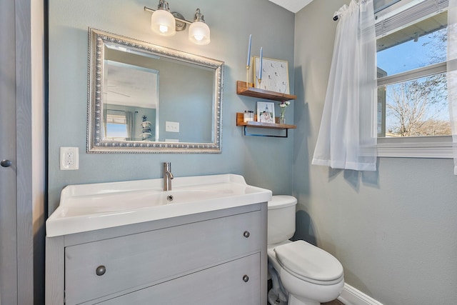 bathroom featuring vanity and toilet