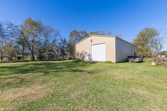 view of yard with a garage and an outdoor structure