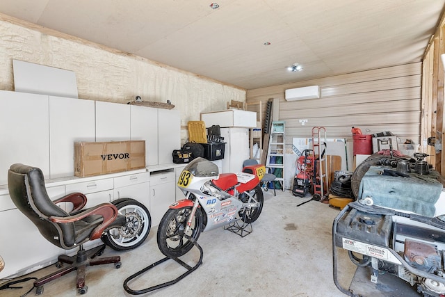 garage with wood walls and a wall mounted AC