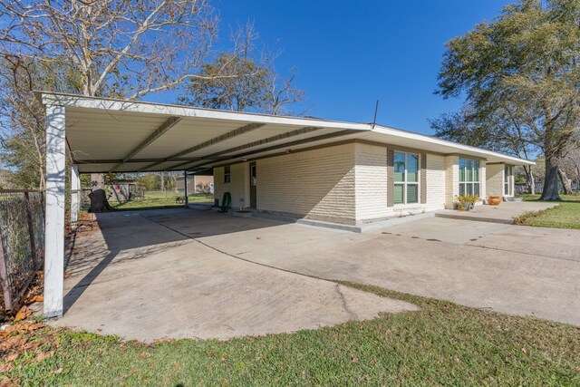 view of parking / parking lot featuring a carport