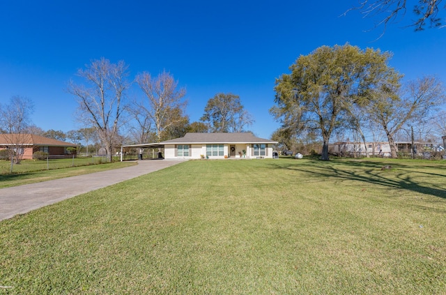 ranch-style home featuring a front yard and a carport