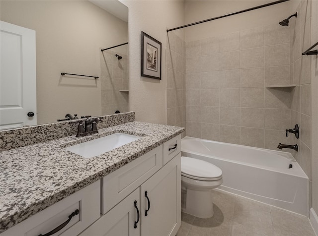 full bathroom with toilet, tiled shower / bath, tile patterned floors, and vanity