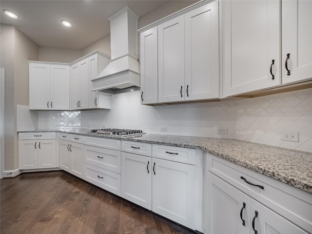 kitchen featuring premium range hood, white cabinets, dark hardwood / wood-style floors, and stainless steel gas cooktop