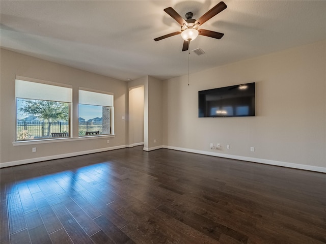 unfurnished living room with ceiling fan and dark hardwood / wood-style floors