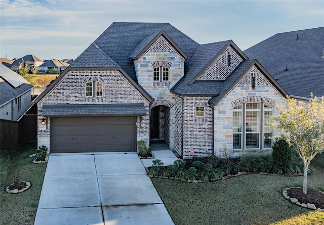 view of front of property with a front lawn and a garage