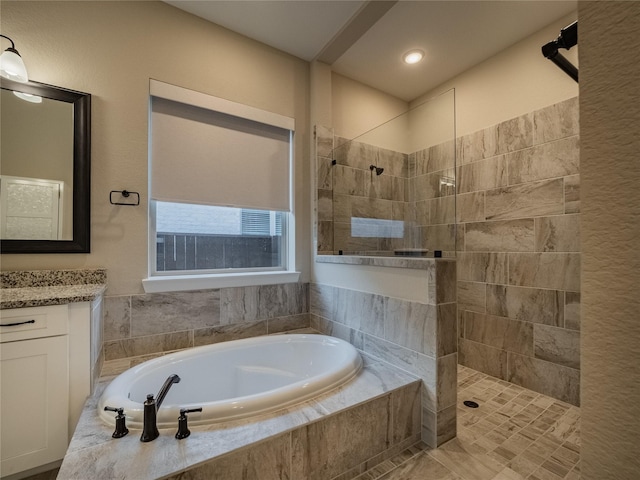 bathroom featuring separate shower and tub and vanity