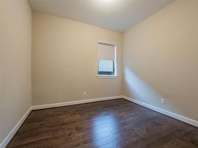 empty room with dark wood-type flooring