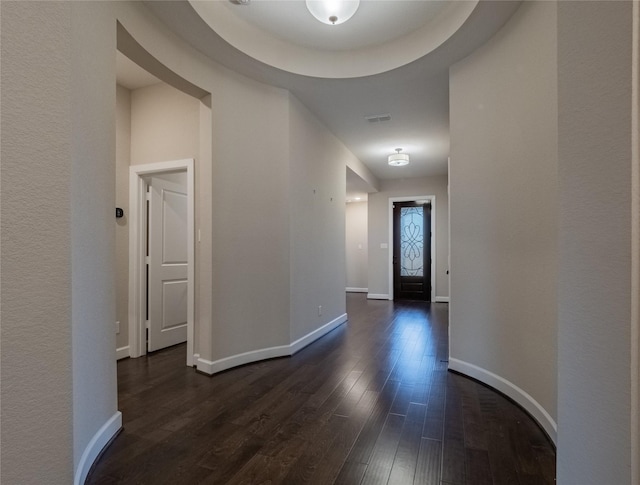 corridor with dark hardwood / wood-style flooring