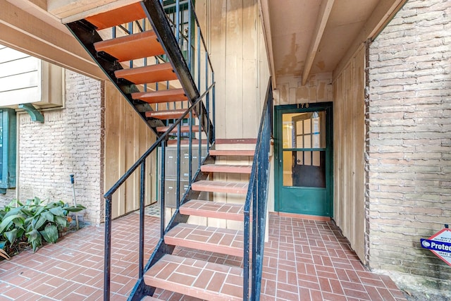 stairway with wood walls