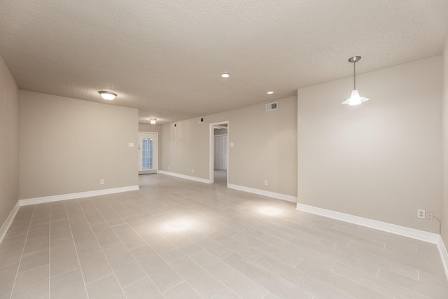 spare room featuring a textured ceiling