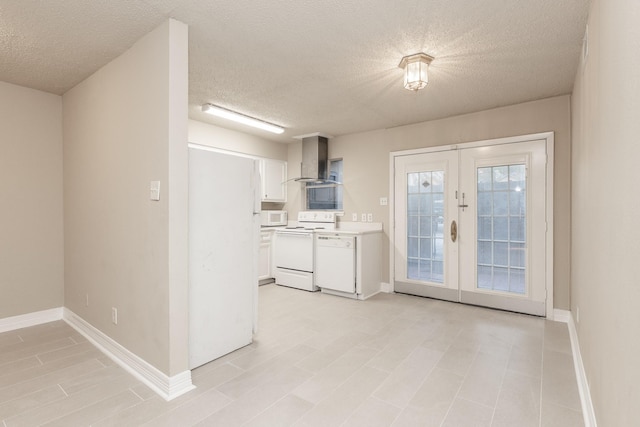 kitchen with french doors, wall chimney range hood, a textured ceiling, white appliances, and white cabinets