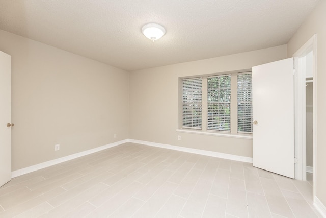 empty room with a textured ceiling