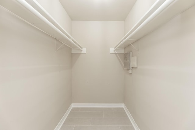 spacious closet with tile patterned floors