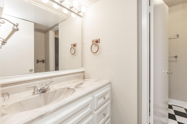 bathroom with vanity and a textured ceiling