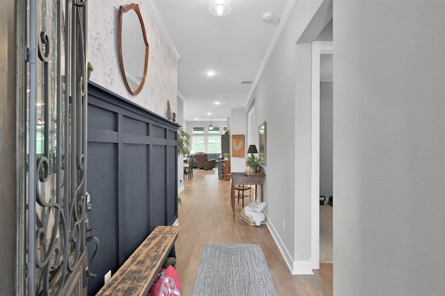 foyer entrance featuring hardwood / wood-style floors and ornamental molding