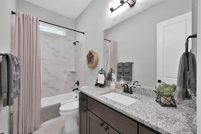 full bathroom with vanity, tiled shower / bath combo, and toilet