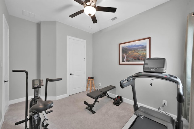 workout area featuring ceiling fan and light colored carpet