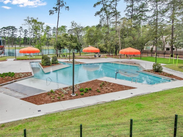 view of swimming pool featuring a yard and a patio