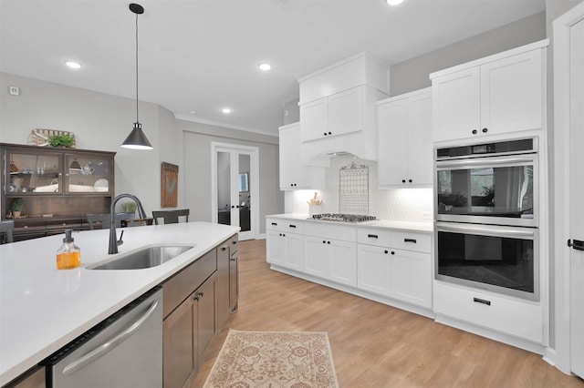 kitchen with white cabinets, stainless steel appliances, and sink