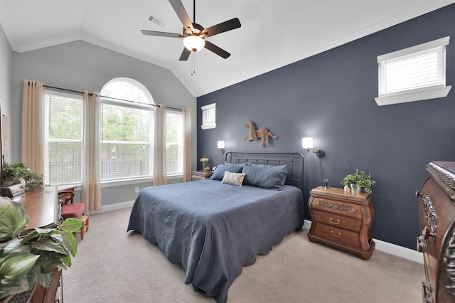 bedroom featuring multiple windows, ceiling fan, light carpet, and vaulted ceiling