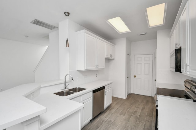 kitchen with white cabinetry, dishwasher, sink, hanging light fixtures, and range