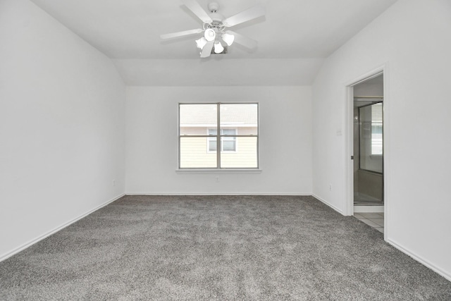 carpeted empty room with ceiling fan and vaulted ceiling