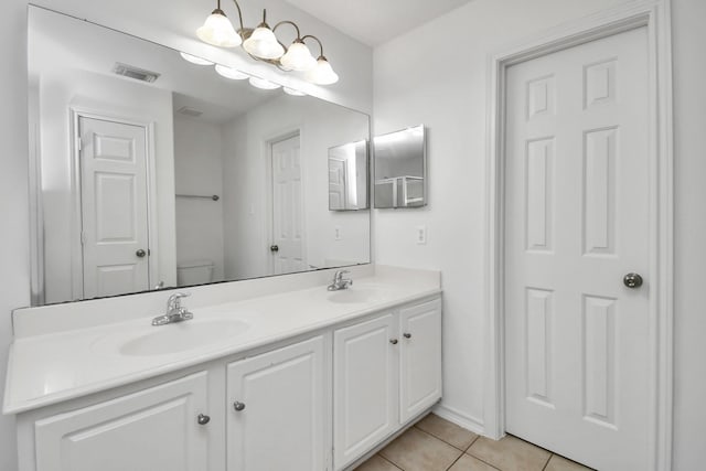 bathroom with tile patterned floors, vanity, and toilet