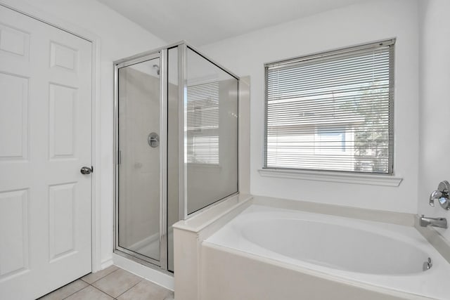 bathroom featuring tile patterned flooring and independent shower and bath