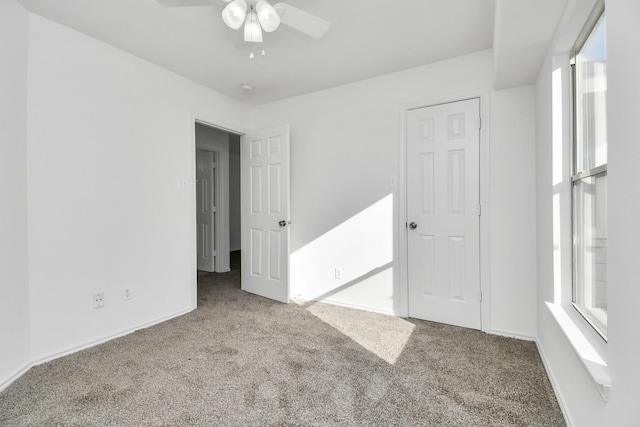 spare room with carpet and ceiling fan