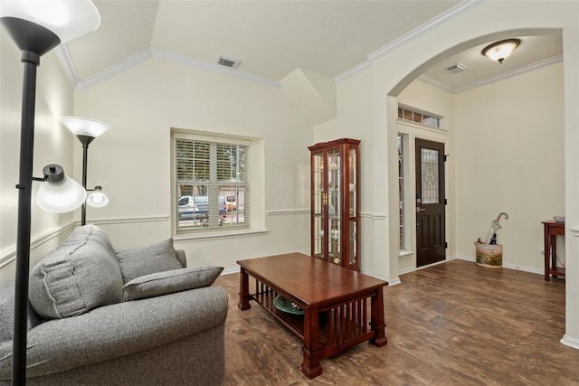 living room featuring dark hardwood / wood-style flooring, ornamental molding, and vaulted ceiling