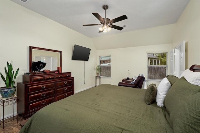 bedroom with multiple windows, vaulted ceiling, and ceiling fan