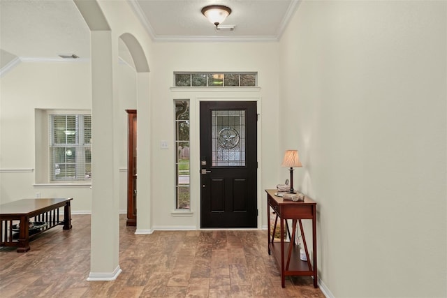 foyer entrance featuring crown molding