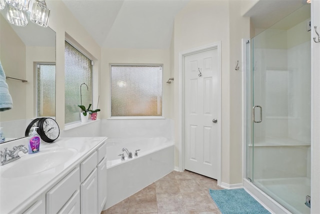 bathroom with tile patterned flooring, vanity, independent shower and bath, and vaulted ceiling