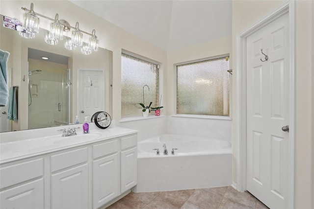 bathroom with tile patterned flooring, shower with separate bathtub, and vanity