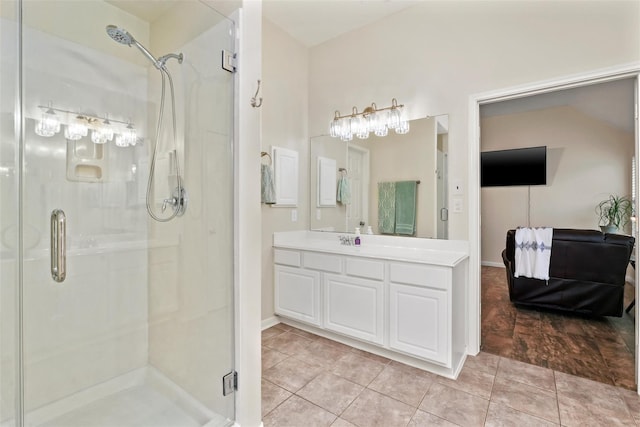 bathroom with tile patterned floors, vanity, and an enclosed shower