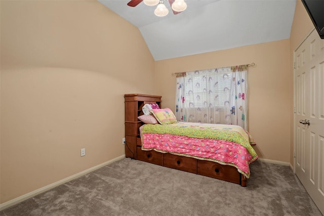 carpeted bedroom with ceiling fan, a closet, and lofted ceiling