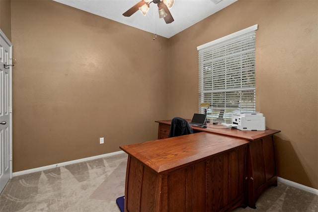 carpeted office space with ceiling fan