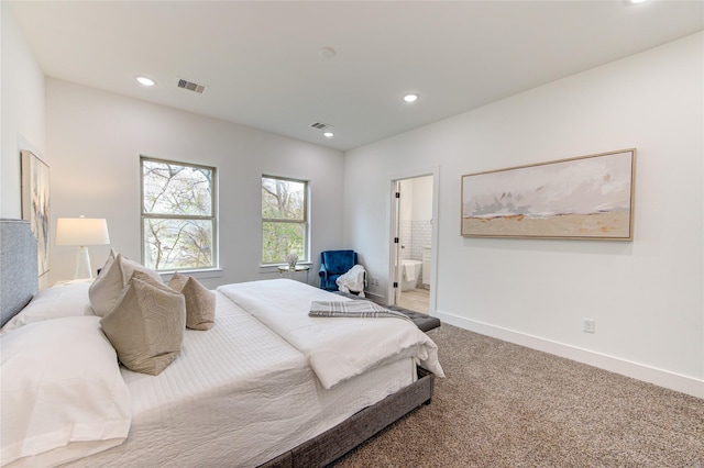 carpeted bedroom featuring ensuite bathroom