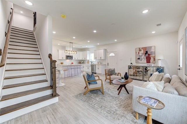 living room featuring light hardwood / wood-style floors and sink