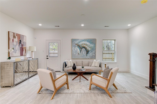 living room featuring light wood-type flooring and a wealth of natural light