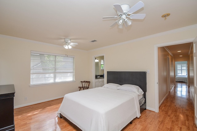 bedroom featuring ensuite bath, light hardwood / wood-style flooring, ceiling fan, and ornamental molding