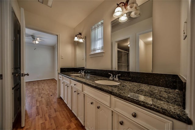 bathroom with vanity, hardwood / wood-style flooring, and ceiling fan