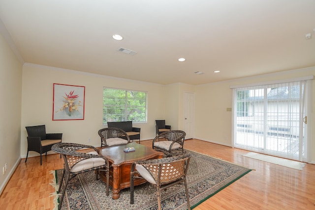 office area with plenty of natural light, light hardwood / wood-style floors, and ornamental molding