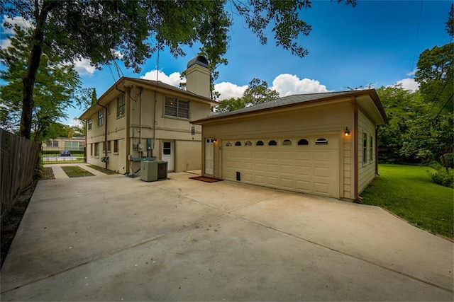 view of front of property featuring central AC unit and a garage