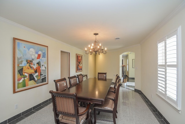 dining area with ornamental molding and a notable chandelier