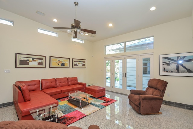 living room with ceiling fan, french doors, and a high ceiling