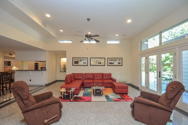 living room featuring french doors, a towering ceiling, and ceiling fan