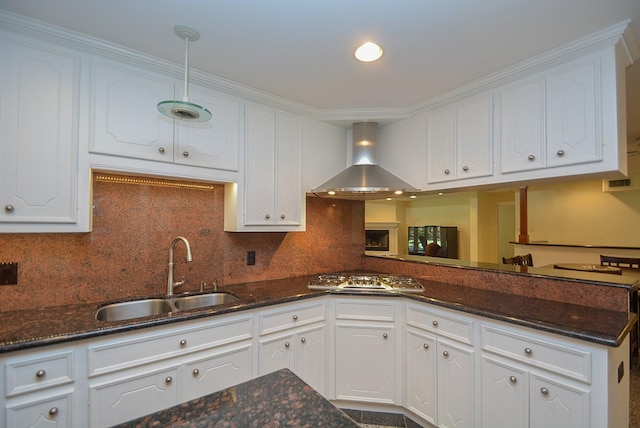 kitchen featuring wall chimney exhaust hood, sink, and white cabinets