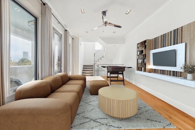 living room featuring hardwood / wood-style floors and ceiling fan