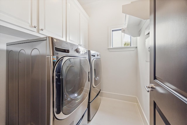 washroom featuring washer and clothes dryer and cabinets